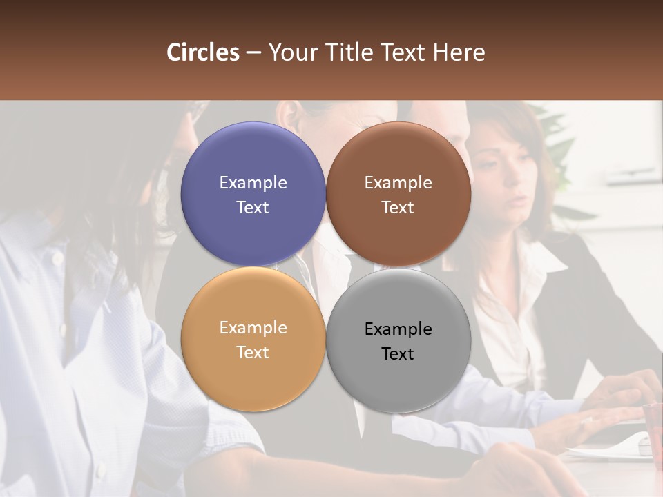 A Group Of People Sitting At A Table Working On A Computer PowerPoint Template
