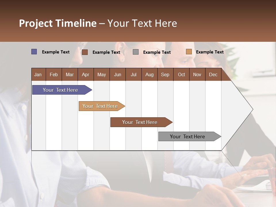 A Group Of People Sitting At A Table Working On A Computer PowerPoint Template