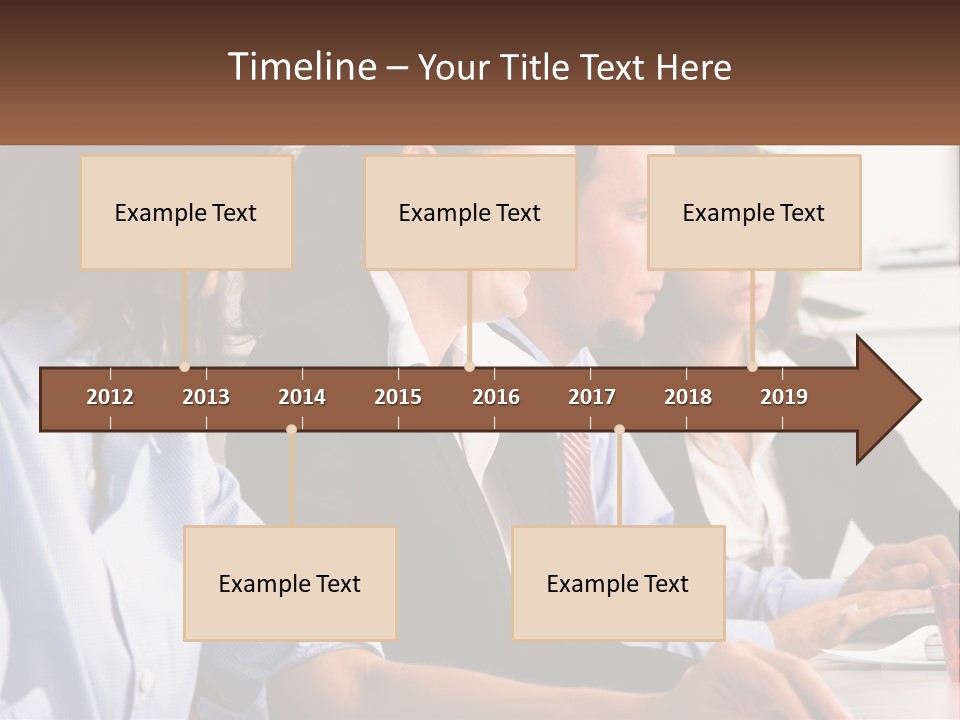 A Group Of People Sitting At A Table Working On A Computer PowerPoint Template