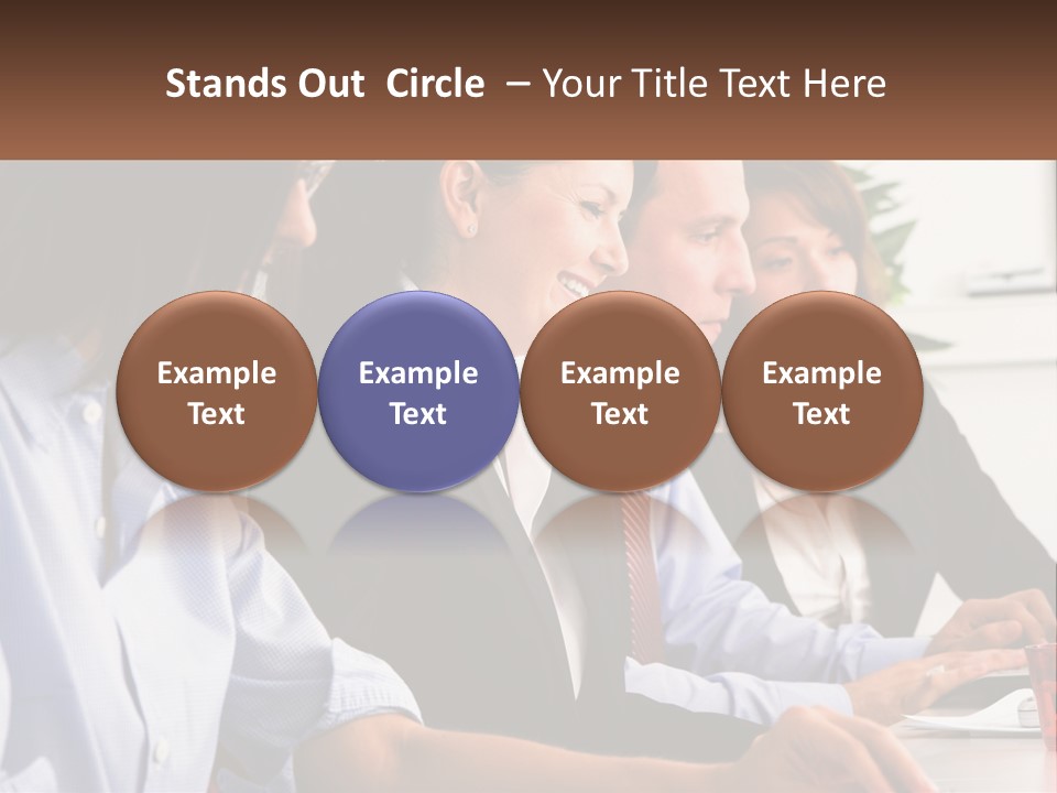 A Group Of People Sitting At A Table Working On A Computer PowerPoint Template