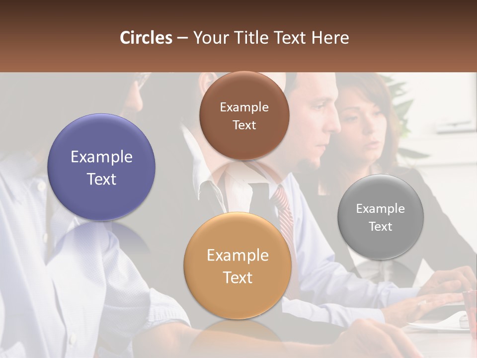 A Group Of People Sitting At A Table Working On A Computer PowerPoint Template